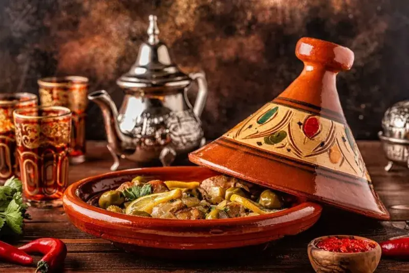 A vibrant display of Morocco Food Tour featuring colorful vegetables and spices arranged on a rustic wooden table.