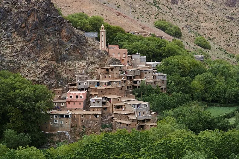 A picturesque village nestled on a mountain slope within the lush forests of Ourika Valley.