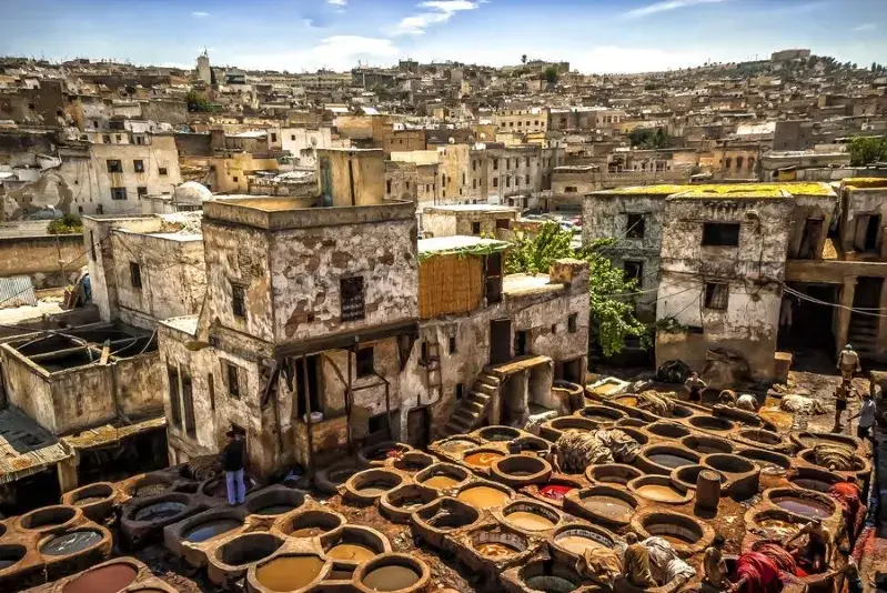 Aerial view of Fes, Morocco, showcasing the cityscape with pots and pans in the foreground.